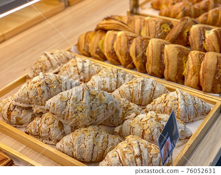 Tray of fresh-baked croissants for sale at pastry shop Tray of fresh-baked croissants for sale at pastry shop 76052631