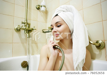 Funny girl in towel. talking on the phone 76052658