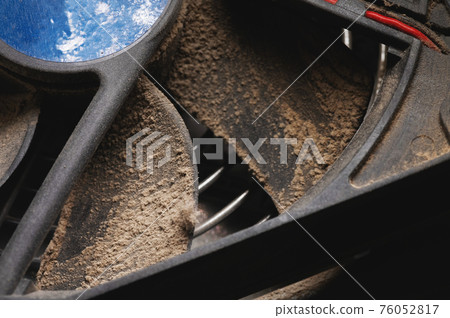 Dust and dirt on the blades of the pc cpu cooler. Close-up 76052817