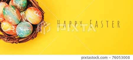 Coloeful easter eggs in nest on yellow color background. Coloeful easter eggs in nest on yellow color background. 76053008