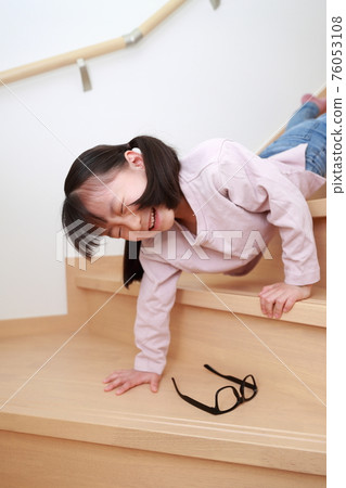 Toddler girl falling down the stairs at home 76053108