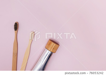 Two wooden bamboo toothbrushes and natural toothpaste Two wooden bamboo toothbrushes and natural toothpaste 76053242