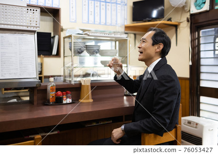 Office worker drinking cold at a set meal shop Office worker drinking cold at a set meal shop 76053427