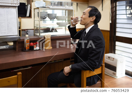 Office worker drinking cold at a set meal shop Office worker drinking cold at a set meal shop 76053429