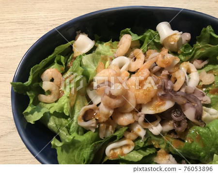 Seafood salad. Squid, octopus and shrimp salad. 76053896