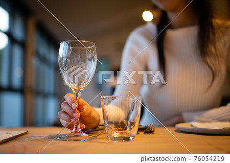 A woman with a wine glass 76054219