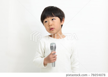 A child talking with a microphone A child talking with a microphone 76054878