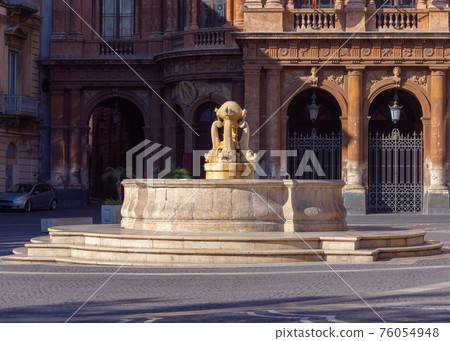 Catania. Catania. The old fountain dolphins in the square in front of the opera. 76054948