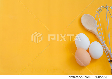 Ingredients for cooking, eggs and kitchen tools on a wooden table top view. 76055816