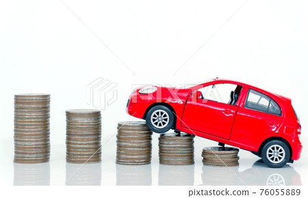 Red miniature car on coin stack : Car loan and leasing time concepts. Car insurance. car model and financial with coins. 76055889