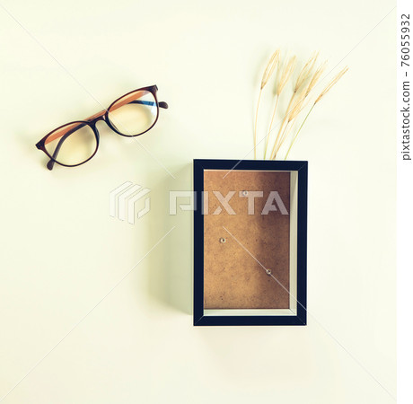 Black frame mockup and glasses with a grass flowers in a on a white background.Portrait orientation. Black frame mockup and glasses with a grass flowers in a on a white background.Portrait orientation. 76055932