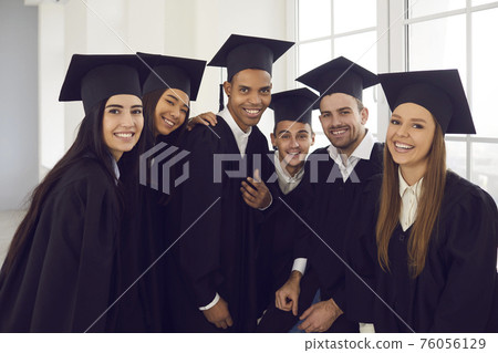 Portrait of a group of students of different nationalities posing by the window in classroom. Portrait of a group of students of different nationalities posing by the window in classroom. 76056129