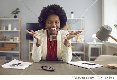 African American business woman talking on online video call with colleagues at work in the office. African American business woman talking on online video call with colleagues at work in the office. 76056163