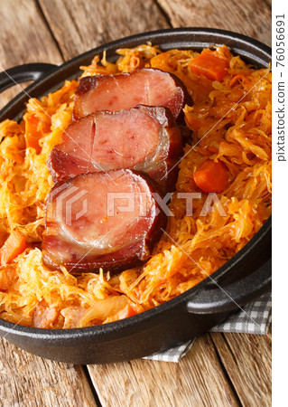Podvarak Serbian Baked Sauerkraut with smoked meat closeup in the pan. Vertical 76056691