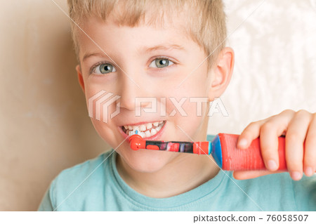 Little child smiling and brushing her teeth close up Little child smiling and brushing her teeth close up 76058507