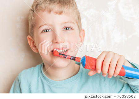 Little child smiling and brushing her teeth Little child smiling and brushing her teeth 76058508