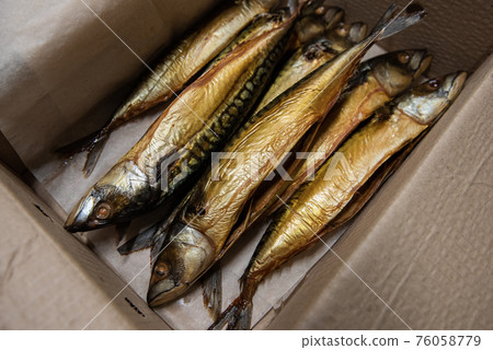Smoked fish in craft paper box. Smoked fish in craft paper box. 76058779