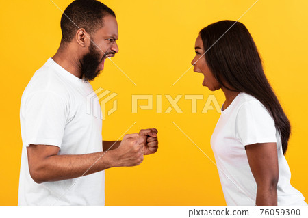 Black couple arguing, woman and man yelling at each other Black couple arguing, woman and man yelling at each other 76059300