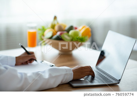 Healthy nutrition specialist giving online consultation, mockup for design on laptop screen Healthy nutrition specialist giving online consultation, mockup for design on laptop screen 76059774