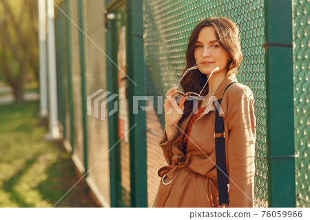 Stylish woman spending time in a spring park 76059966
