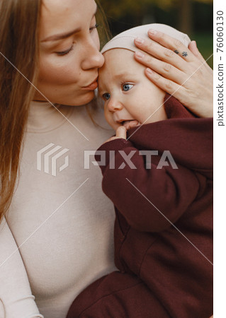 Cute and stylish family in a autumn park Cute and stylish family in a autumn park 76060130