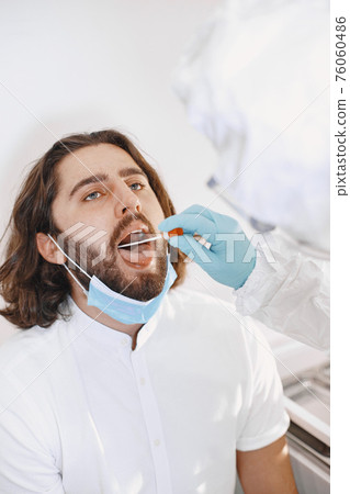 Medical worker taking a swab for corona virus Medical worker taking a swab for corona virus 76060486