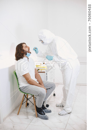 Medical worker taking a swab for corona virus Medical worker taking a swab for corona virus 76060488
