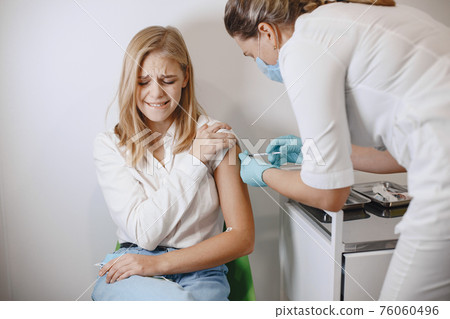 Woman doctor gives a vaccine to patients Woman doctor gives a vaccine to patients 76060496
