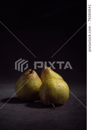 pears on a dark background 76060641