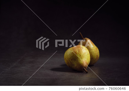 pears on a dark background 76060646