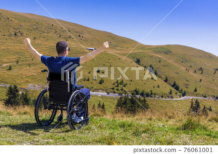 optimistic handicapped man sitting on wheelchair 76061001