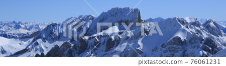 Winter landscape in St Gallen Canton. Snow covered mountain ranges. 76061231