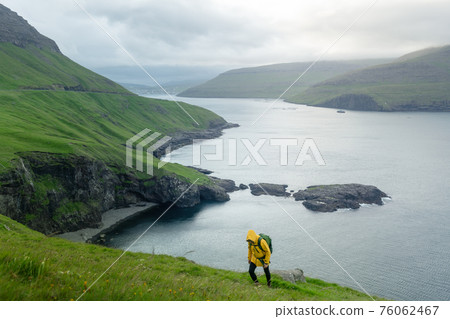 Dramatic view of green hills of Vagar island and Sorvagur town 76062467