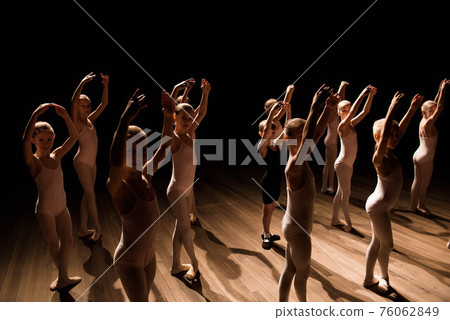 A large group of children rehearsing and dancing the ballet. A large group of children rehearsing and dancing the ballet. 76062849
