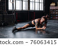 Young girl doing sports in the gym. Atmospheric gym 76063415