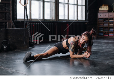 Young girl doing sports in the gym. Atmospheric gym Young girl doing sports in the gym. Atmospheric gym 76063415