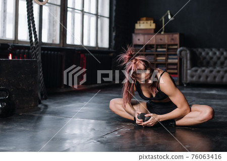 Young girl doing sports in the gym. Atmospheric gym 76063416