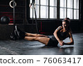 Young girl doing sports in the gym. Atmospheric gym 76063417