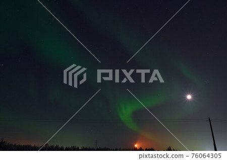 northern light on the silent field before sun rise. northern light on the silent field before sun rise. 76064305