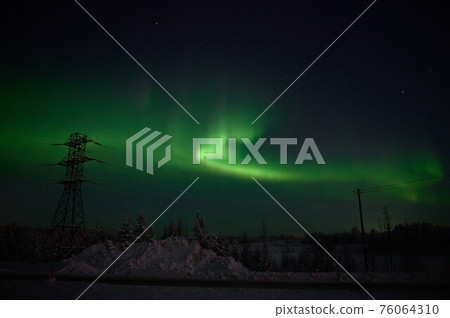 northern light on the silent field before sun rise. northern light on the silent field before sun rise. 76064310