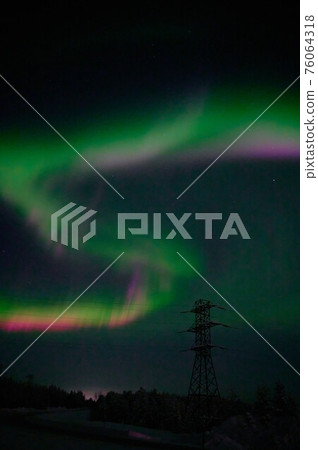 northern light on the silent field before sun rise. northern light on the silent field before sun rise. 76064318