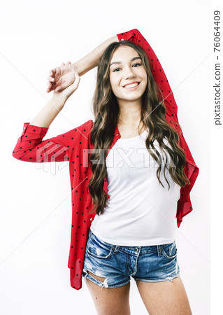 young pretty teenage hipster girl posing emotional happy smiling on white background, lifestyle people concept close up young pretty teenage hipster girl posing emotional happy smiling on white background, lifestyle people concept close up 76064409