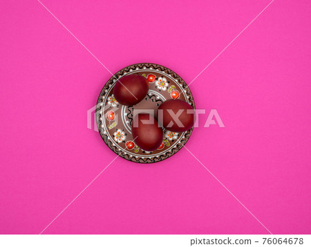 Easter eggs on a plate. Pink background. Spring holiday treat. Easter eggs on a plate. Pink background. Spring holiday treat. 76064678