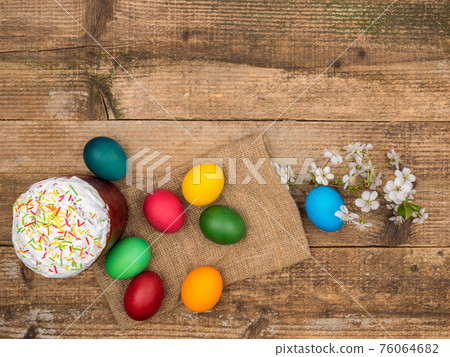 Easter cake and painted eggs on a wooden background. Easter cake and painted eggs on a wooden background. 76064682