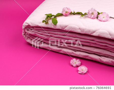 Pink plaid and a flowering sprig of almonds close-up. Pink plaid and a flowering sprig of almonds close-up. 76064691