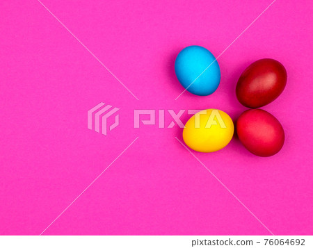 Bright painted eggs for Easter. Pink background. 76064692