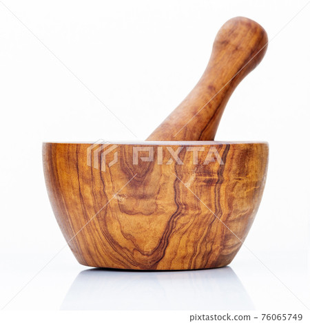 Closeup handmade wooden mortar and pestle isolated on white background . 76065749