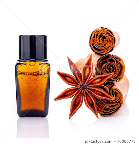 Cinnamon essential oil bottle with Ceylon cinnamon sticks and anise star isolated on white background . 76065775