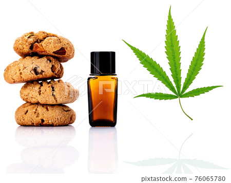 Homemade cannabis cookies with cannabis oils of marijuana isolated on white background. Food conceptual with cannabis herb. Homemade cannabis cookies with cannabis oils of marijuana isolated on white background. Food conceptual with cannabis herb. 76065780