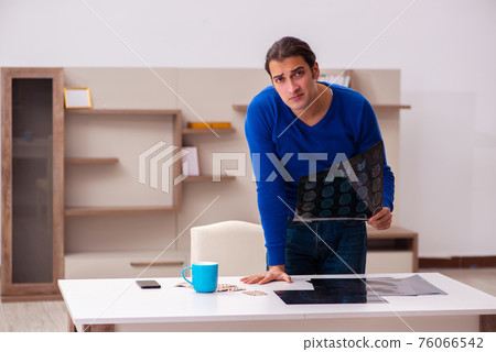 Young sick man suffering at home 76066542
